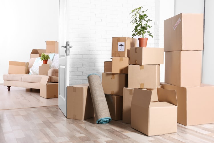 A pile of boxes in an empty room