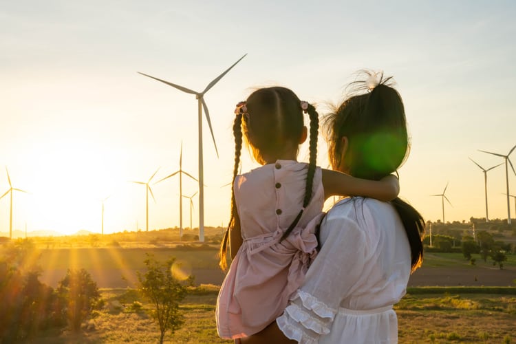 A woman and child admiring wind turbines.