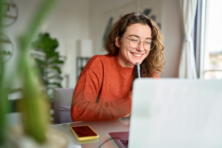 Happy woman working on her laptop.