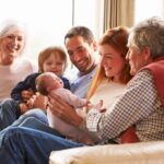 A multi-generational family sitting on the sofa.