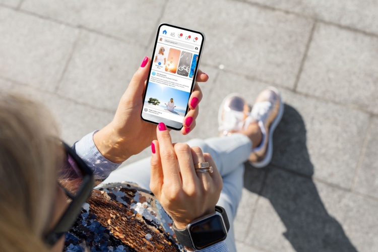 A woman looking at social media on her phone.