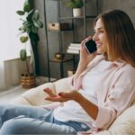 A woman talking on the phone at home.