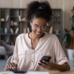 A woman looking at investment performance on her phone.