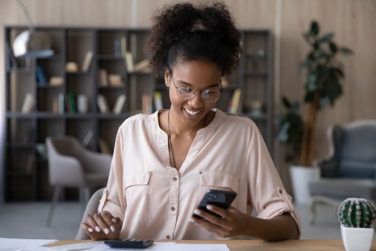 A woman looking at investment performance on her phone.