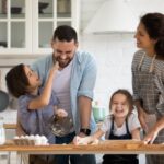 A family with young children baking together.