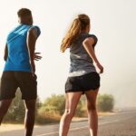 Three people running outdoors.