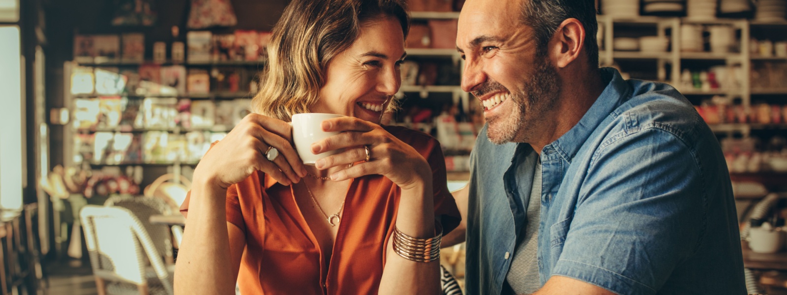 A couple laughing in a café.