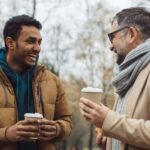 Two men talking together outdoors.