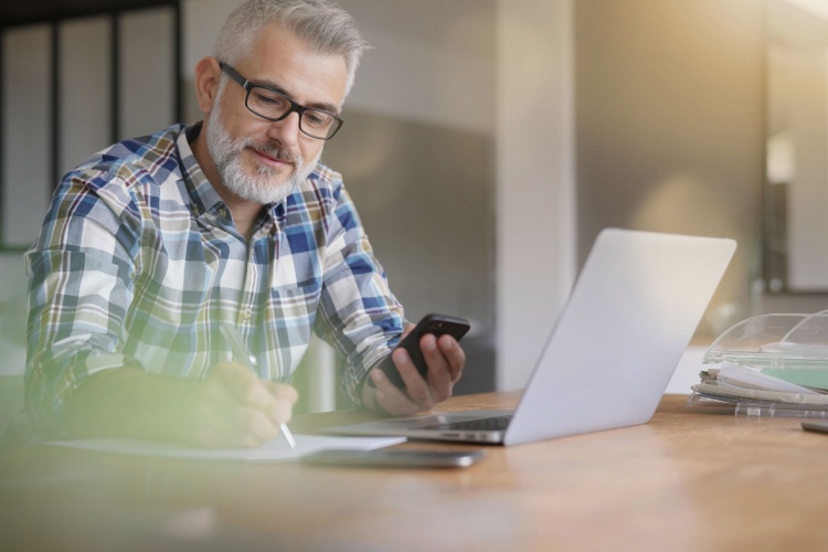 A man using a computer in a home office.