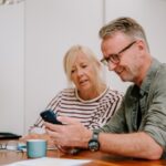 A couple going through paperwork together.