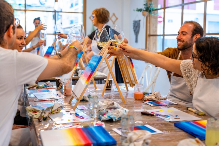 A group of people attending a painting workshop.