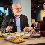 A couple enjoying a meal in a restaurant together.