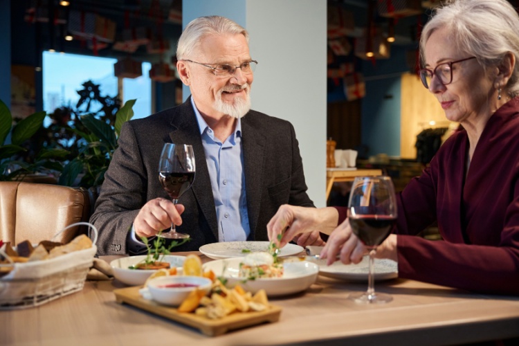 A couple enjoying a meal in a restaurant together.