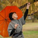 A woman under an umbrella.