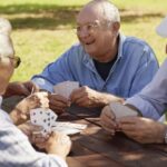 A group of friends playing cards outdoors.