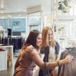 Two women clothes shopping.