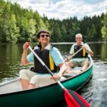 A couple on holiday taking a canoe ride.