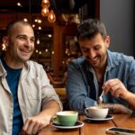 Two men talking in a café.