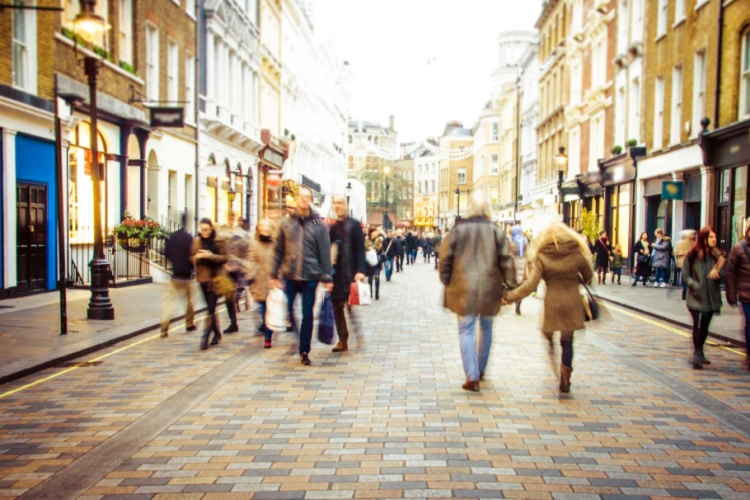 People walking down a high street.
