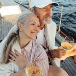 A couple sitting on a yacht deck.