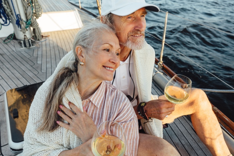 A couple sitting on a yacht deck.