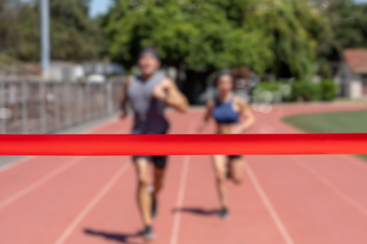 Runners running towards a finish line.
