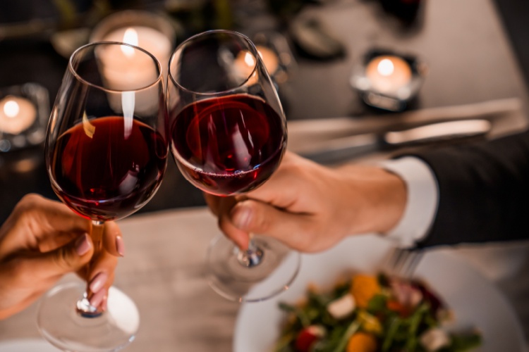 A couple toasting with wine glasses.
