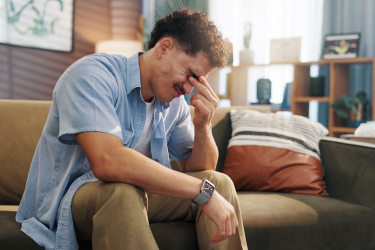 A stressed man with his head in its hand.