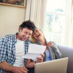 A happy couple reviewing paperwork.