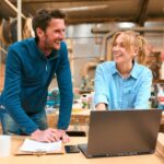 Two people in a woodwork workshop.