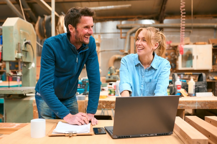Two people in a woodwork workshop.