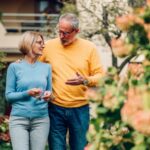 Mature couple walking outside a house