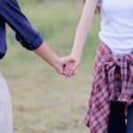 Two women holding hands.